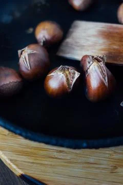 Roated chestnuts on pan Stock Photos