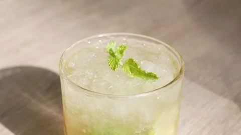 Roating view of a glass of refreshment ice mojito cocktail alcohol drink wi.. Stock Footage 274485753