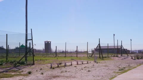 Robben Island prison grounds. Security fencing and prison tower. HD50p Stock Footage 242014448