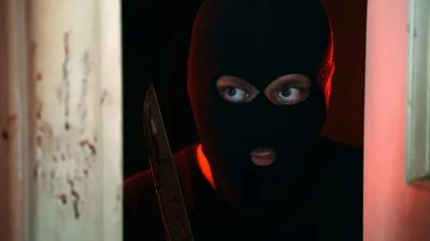 A robber after committing a murder holding bloody knife. Face of criminal in 스톡 동영상 122101145