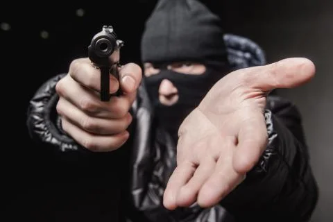 Robber with an aming gun Stock Photos