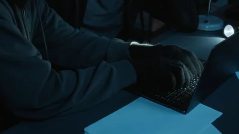 Robber and Anonymous Accomplice Trying to Crack Password for Office Laptop Stock Footage 321682545