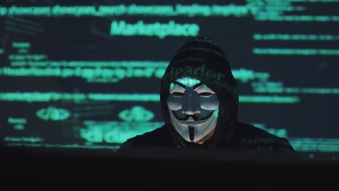 Robber in the background running program code. hacker in the mask hacks the Stock Footage 90254150