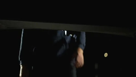 Robber in balaclava opening car trunk and stealing money, crime, security system Stock Footage 95060419