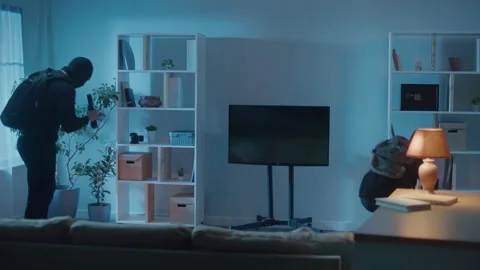 Robber in Black Clothes and a Mask Broke Into an Apartment or House. Stock-Footage 239598446
