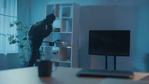 Robber in Black Clothes and a Mask Broke Into an Apartment or House. Stock Footage 239884057