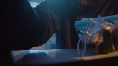 A Robber in a Black Mask Opens the Safe and Steals Money and Jewelry. Close-Up Stock Footage 239889820