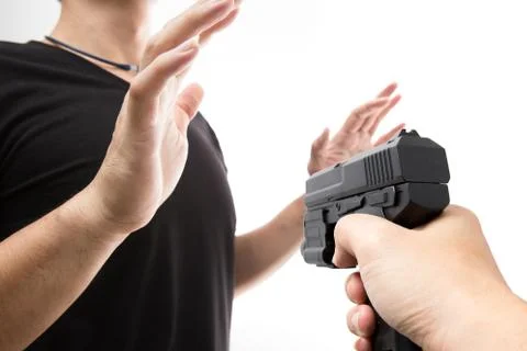 Robber with a gun robbing intimidate a man surrender. Isolated white backgrou Stock Photos