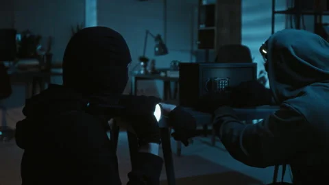 Robber Looking around Office Room while Accomplice Struggling to Break into Safe Stock-Footage 321680693