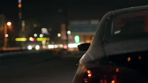 Robber man checking breaking entering alarm shines a flashlight in a car Vídeos de archivo 110888729