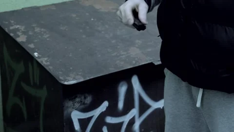 A robber or bandit on the street opens a knife and threatens to use a standard Stock Footage 320634750
