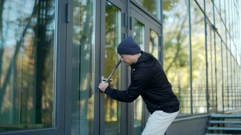 Robber tries to break open the door of the house or office but he fails to hear  Stock Footage 165617802