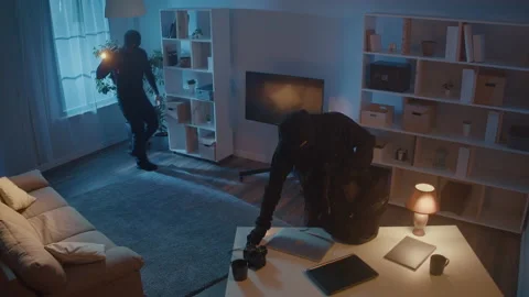 Robbers with a Flashlight Broke Into House Puts Everything in Backpack, Take TV Video stock 239884693