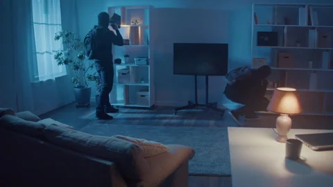 Robbers Scared and Run When a Police Car Lights Flood Into the Room. Stock Footage 239883837