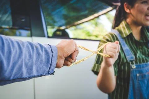 The robbers wore a hooded cap, using a gun to hijack gold from women. Stock Photos