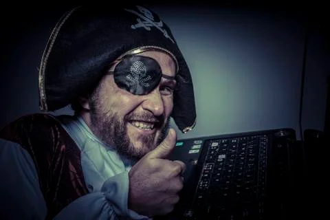 Robbery, computer security, hacker pirate dress with hat and skull Stock Photos