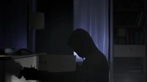 Robbery, a thief in black clothes and a balaclava rummages through other people Stock Footage 305925728
