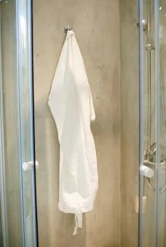 Robe on the rack in the bathroom Stock Photos