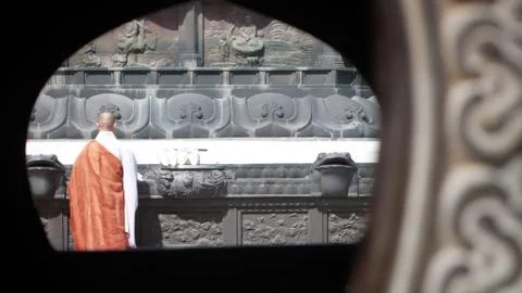Robed buddhist monk performs ritual Stock Photos