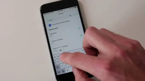 Robinhood phone application Game Stop stock ticker Stock Footage 147959664