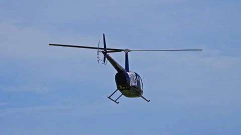 Robinson Helicopter View from Below Against Blue Sky Stockbeeldmateriaal 321424734