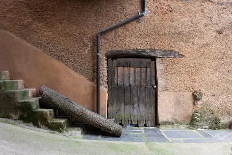 ROBLEDILLO DE GA, SPAIN - Mar 27, 2021: An old wooden door with a wrought iro Stock Photos