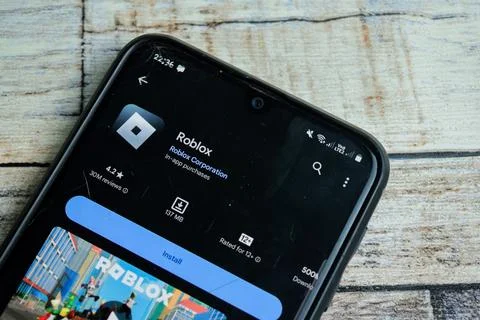 Roblox application on Smartphone screen. Roblox is a freeware Stock Photos