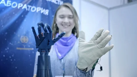 Robo-arm repeats the movements of the human hand. The plastic arm of a robot is Stock Footage 109486355