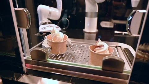 A Robo hand is serving the ice cream cups, robot chef footage Stock Footage 252107844