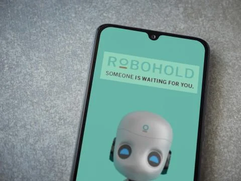 RoboHold app launch screen with logo on the display of a black mobile smartph Stock Photos