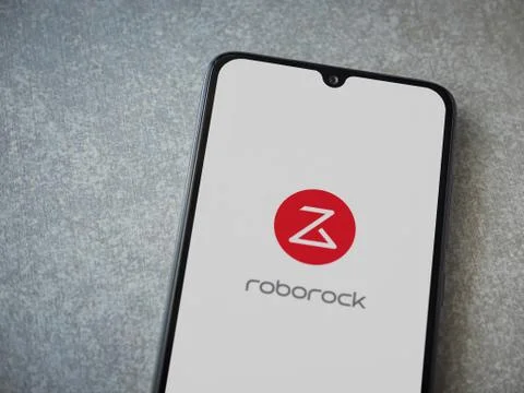 Roborock app launch screen with logo on the display of a black mobile smartph Stock Photos