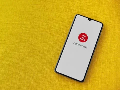Roborock app launch screen with logo on the display of a black mobile smartph Stock Photos