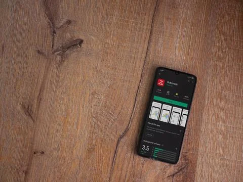 Roborock app play store page on the display of a black mobile smartphone on w Foto stock
