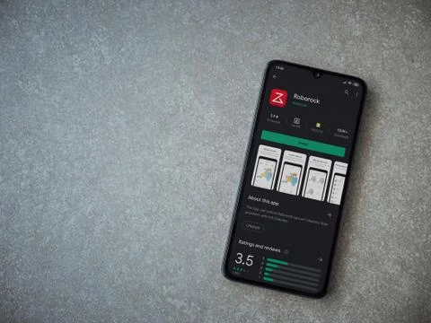 Roborock app play store page on the display of a black mobile smartphone on c Foto stock