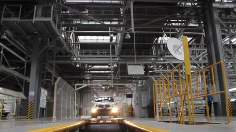 Robot 046A new car is moving to a test bench at a car factory. Stock Footage 123765641