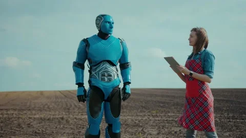 Robot and human cooperation. Future technology in agriculture. Young woman Stock Footage 133288990
