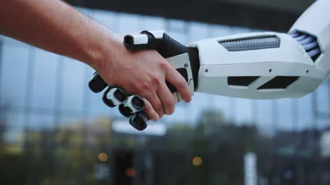 Robot and man shaking hands on sunny day outdoors. Future technology. Modern Stock Footage 233893349