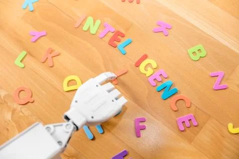 Robot arm and the word intelligence Stock Photos