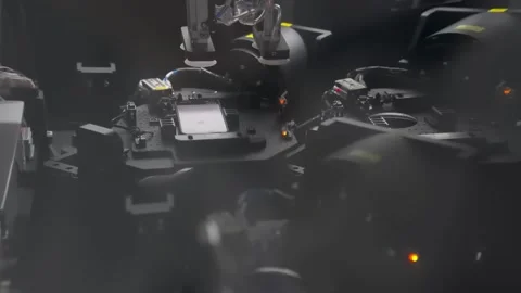 Robot arm assembling smartphone screen in automated machine 動画素材 347981349