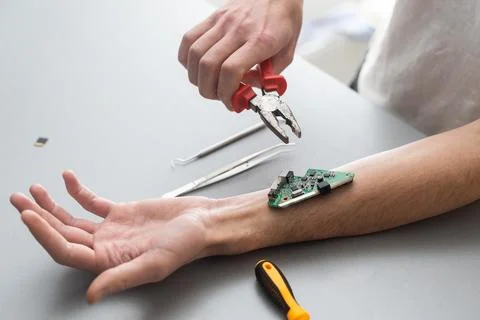 Robot arm concept. Man shows biomechanical prosthetic hand. Guy repairs his hand Stock Photos