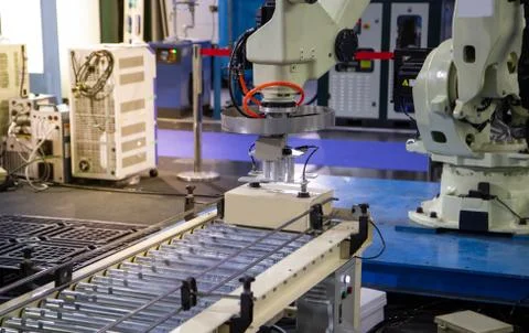 Robot arm loading in factory Stock Photos