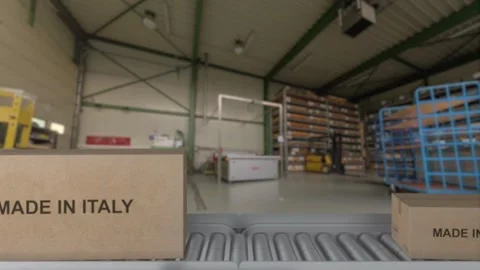 The Robot arm picks up the cardboard box Made in ITALY. Cardboard boxes with Stock Footage 274366017