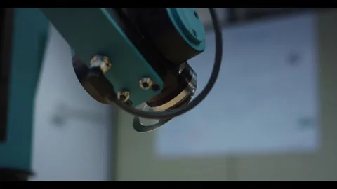 Robot arm placing metal part in a factory, close up detail shot 動画素材 341252102