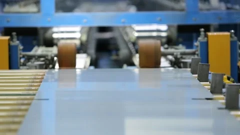 Robot arm puts sheet metal into rolling machine Stock Footage 162917293