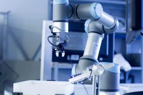 Robot arm in a sensor technology plant Stock Photos