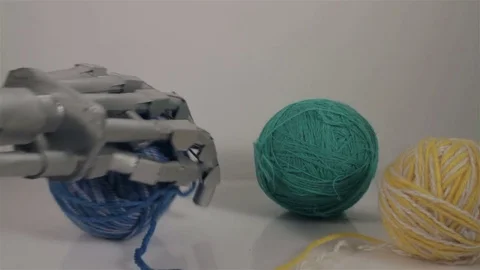 The robot arm is trying to take a ball of yarn Stock Footage 72166219