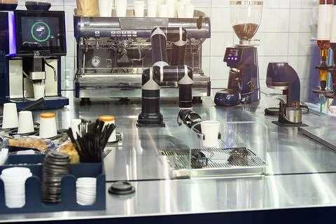 Robot with artificial intelligence making coffee on coffee machine Stock Photos