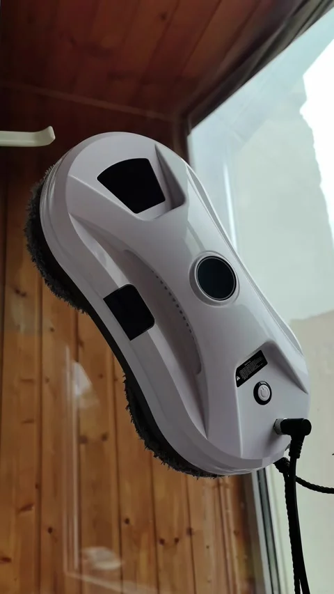 A robot cleaner of windows and walls, modern equipment for cleaning the house. Stock Footage 317766262