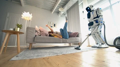 Robot is cleaning while the woman is talking on the phone. Smart home concept. 스톡 동영상 116612336