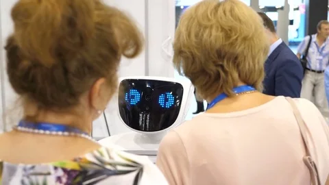 Robot communicates with people. Interaction of the robot and the person. Modern Stock-Footage 80726477
